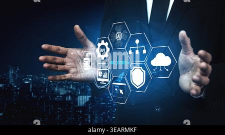 Businessman Presenting Futuristic Technology Concepts of No Code, API Integration, AI Solutions, Data Security, and Cloud Computing in a Night Stock Photo