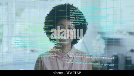 Smiling woman wearing pale pink blouse facing camera in modern office with green grid code overlay. Portrait, workspace, futuristic, holographic, digi Stock Photo