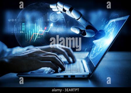 A robotic hand interacts with a laptop while displaying a digital interface. This image symbolizes the convergence of technology and human effort in Stock Photo