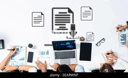 A group of professionals collaborates on data analysis in a modern office. Laptops, charts, and document icons emphasize teamwork and productivity in Stock Photo