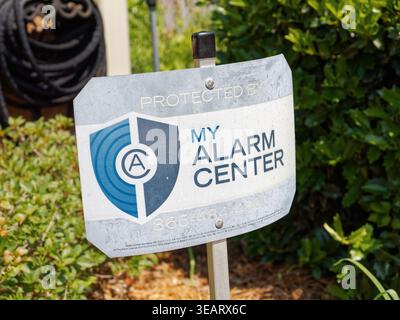 Alarm system warning sign in front of a residential home warning of a home alarm or security system in Pike Road Alabama, USA. Stock Photo
