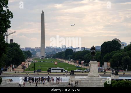 Washington DC, USA - 14 June 24: Long view across the National Mall toward the Washington Monument with an airplane in the sky, Washington, DC, USA. Stock Photo