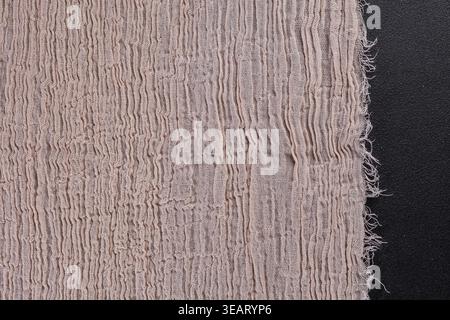 Raw Edge Beige Muslin Fabric Texture on Black Background Stock Photo