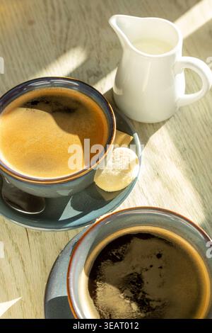 Close up of a coffee and biscuit on a table Stock Photo