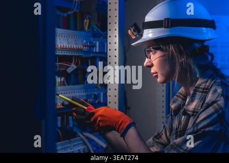 Electrician inspecting electrical system with voltage tester. Engineering inspection. Stock Photo