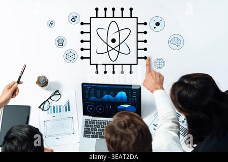 Professionals engage in teamwork discussing digital technology as they analyze data visualization on a laptop, with scientific graphics enhancing the Stock Photo