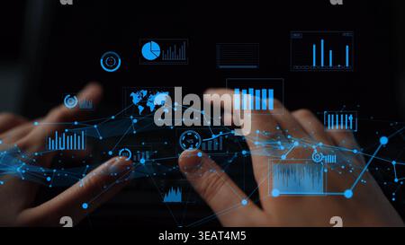 A close-up of hands interacting with digital visualizations and graphs on a laptop screen, symbolizing analytics, technology, and the digital Stock Photo