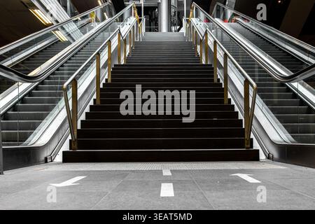 Low angle view of empty stairs and escalators in subway. Urban design and city infrastructure. Stock Photo