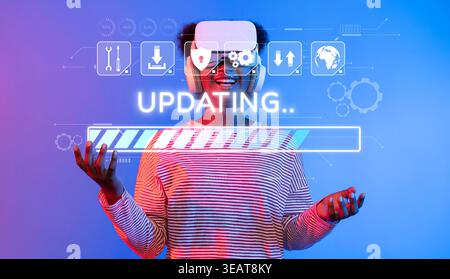 A young individual wearing a virtual reality headset engages in a software update, visualizing a progress bar, representing modern technology and Stock Photo