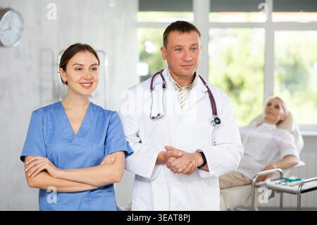 Female and male medical colleagues are standing in medical office hospital Stock Photo