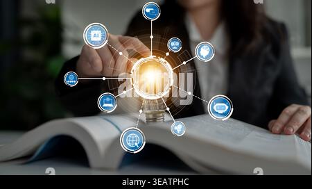 A businesswoman is exploring innovative ideas through digital icons emerging from an open book, illustrating the fusion of knowledge and technology in Stock Photo