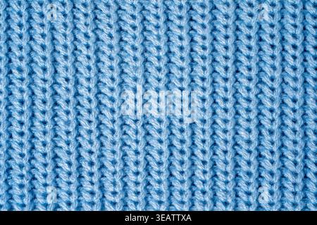 Close-up sweater texture in blue color, showing knitted surface, soft loops and pattern in macro detail. Concept of tactile textile quality, synthetic Stock Photo