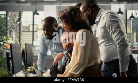 Employees reviewing charts and diagrams during a project briefing. Corporate manager leads discussions on planning, documentation and report writing to enhance business intel. Stock Photo