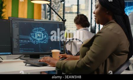 System administrators doing brainstorming in office, using specialized hardware to accelerate complex AI calculations. Engineering team managing systems for deep learning training datasets, camera B Stock Photo