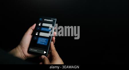 AI assistant concept. Hands using a smartphone with a chatbot interface and message bubbles. Large language models, artificial intelligence, mobile pe Stock Photo