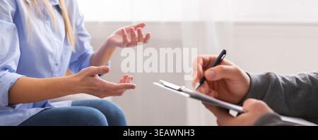 Young woman having discussion with personal therapist Stock Photo
