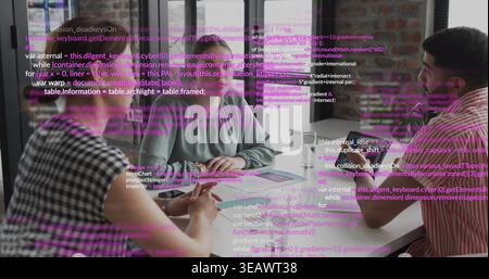 Discussing three colleagues reviewing laptop and marked papers in meeting room, purple code overlay Stock Photo