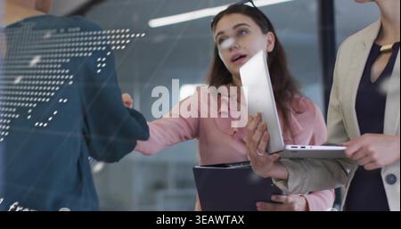 Reaching woman in pink blouse extending hand in office near glass map, holding tablet, folder Stock Photo