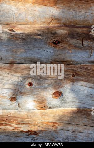 A close view of weathered kelohonka logs showing natural grain, aged surfaces and rustic Nordic character. The organic texture and varied tones make t Stock Photo