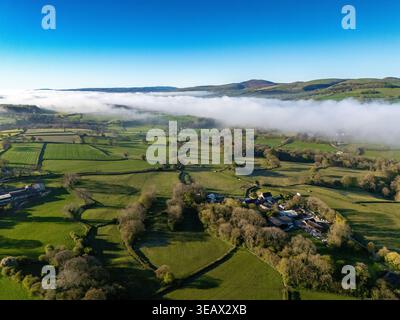 Flintshire, Wales. UK Weather: 24 April 2026, Temperatures are to get in the early 20 degrees centigrade for many today including areas of North Wales. Morning mist starting to burn the away near the village of Lixwm with the Clwydian Range hills in the distance, Flintshire, North Wales.  ©DGDImages/Alamy Live News Stock Photo