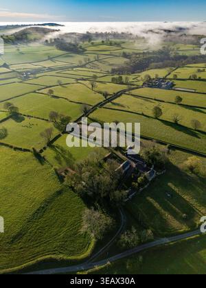 Flintshire, Wales. UK Weather: 24 April 2026, Temperatures are to get in the early 20 degrees centigrade for many today including areas of North Wales. Morning mist starting to burn the away near the village of Lixwm with the Clwydian Range hills in the distance, Flintshire, North Wales.  ©DGDImages/Alamy Live News Stock Photo