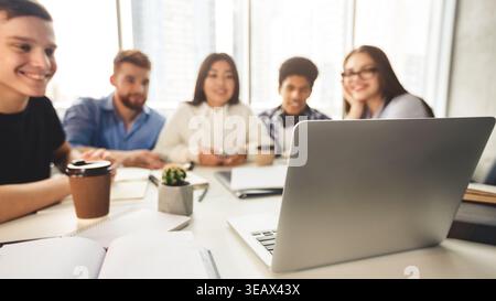 Happy international students preparing for upcoming exams, using laptop Stock Photo