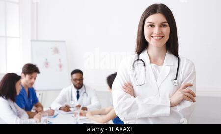 Happy Doctor With Stethoscope Posing To Camera Stock Photo