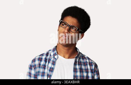 Thoughtful Afro Guy Thinking and Looking Aside Stock Photo