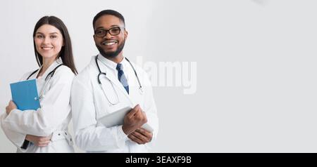 Happy Medic Workers. Portrait Of Two Doctors In White Coats Stock Photo