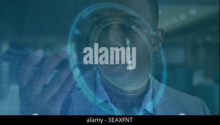 Pointing man in blazer, collared-shirt using circular HUD with raised hand at office with blue grid Stock Photo