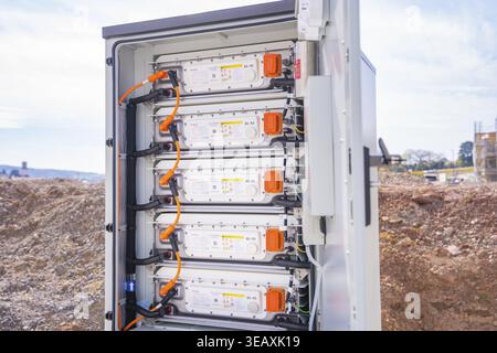 Opened control cabinet with batteries and electrical wiring outdoors, Goodwe battery energy storage on farm, Moensheim, Germany Stock Photo