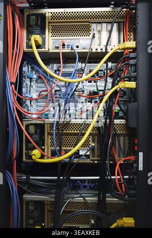 Rack, cables and computing equipment in server room for database storage, cybersecurity or hardware. IT system, closeup or wiring in data center for Stock Photo
