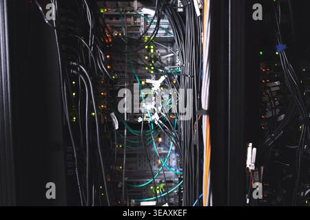 Hardware, wiring or computing equipment in server room for database storage, cybersecurity or tech. IT infrastructure, rack or cables in data center Stock Photo