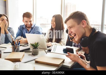 Young people enjoying group study in college library Stock Photo