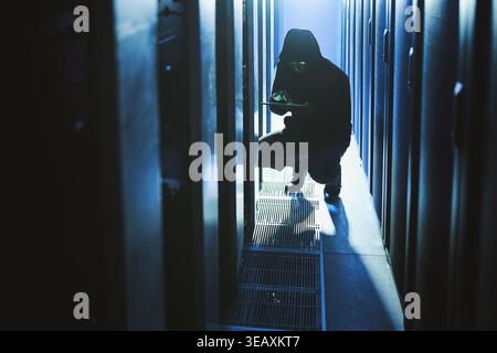Hacker, coding and tablet in data center at night for malware, cyberattack and ransomware. Suspicious, person and digital with code script for hacking Stock Photo