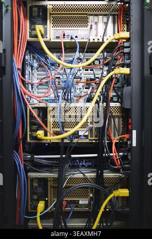Rack, wiring and computing equipment in server room for database storage, cybersecurity or hardware. IT system, closeup and cables in data center for Stock Photo