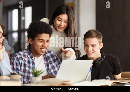 Group of Students Collaborating on a Project at a Modern Study Space During Afternoon Hours Stock Photo