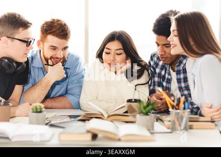Group of Students Studying Together and Discussing Ideas at a Modern Workspace Stock Photo