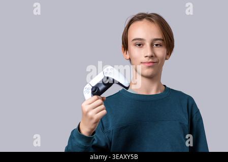 Gamer hand using video game console controller. Playing games concept. Man play a football game with video game controller. Child holding a game Stock Photo
