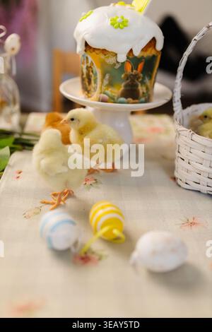 Easter table with traditional cake and cute chicks Stock Photo