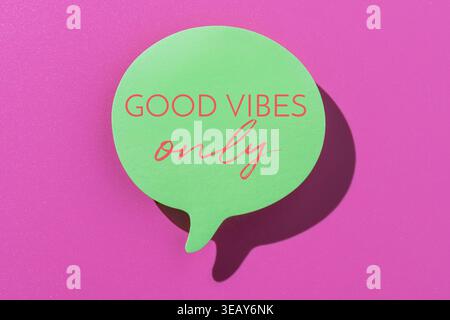A green speech bubble with text GOOD VIBES ONLY in pink typography on a pink background. A pop-art style concept representing motivation, positivity, Stock Photo