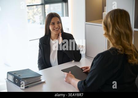 Beautiful woman consulting with professional beautician in beauty center Stock Photo
