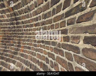 Curved red brick wall texture useful as a background Stock Photo