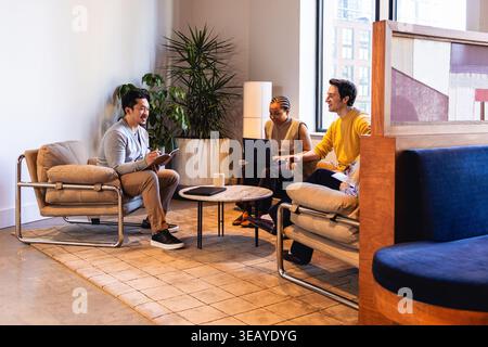 Group of Office Colleagues collaborating in modern environment Stock Photo