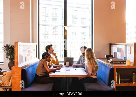Group of Four Young Adults in Office Team Environment Stock Photo