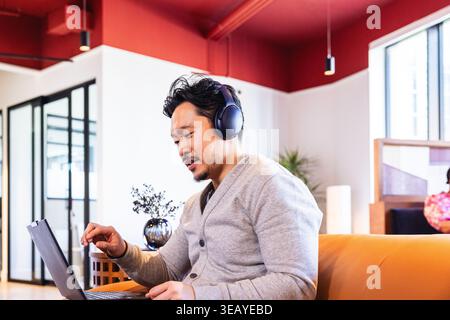 Asian Businessperson Using Laptop during meeting at office Stock Photo