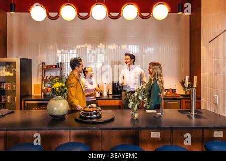 Casual Office Team Talking in Kitchen Workspace Stock Photo