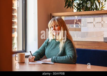 Young caucasian woman sitting at the office Stock Photo