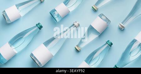 Many bottles of clean water on light blue background, top view. Pattern for design Stock Photo