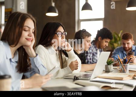 Students Engaged in Study Session at Modern Workspace During Afternoon Stock Photo